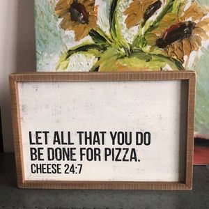 Wall sign “Let all that you do be done for pizza”